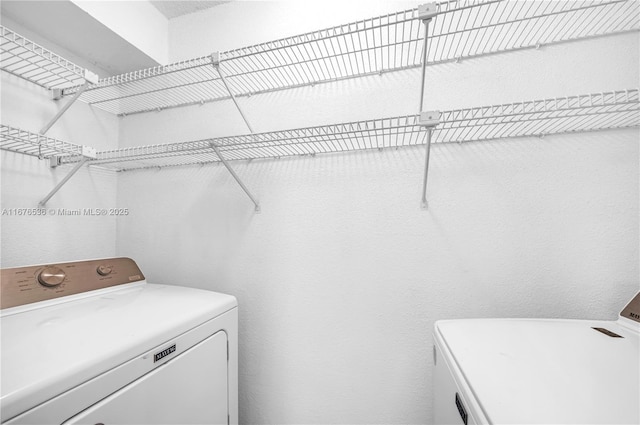 washroom featuring separate washer and dryer and laundry area