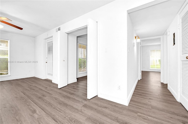 unfurnished bedroom with multiple windows and wood finished floors