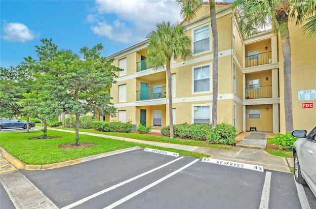 view of property featuring uncovered parking