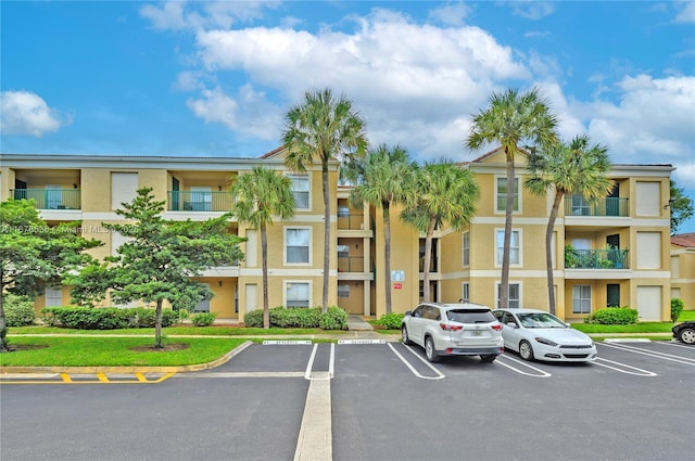 view of building exterior with uncovered parking