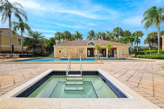 view of swimming pool with a community hot tub and a patio