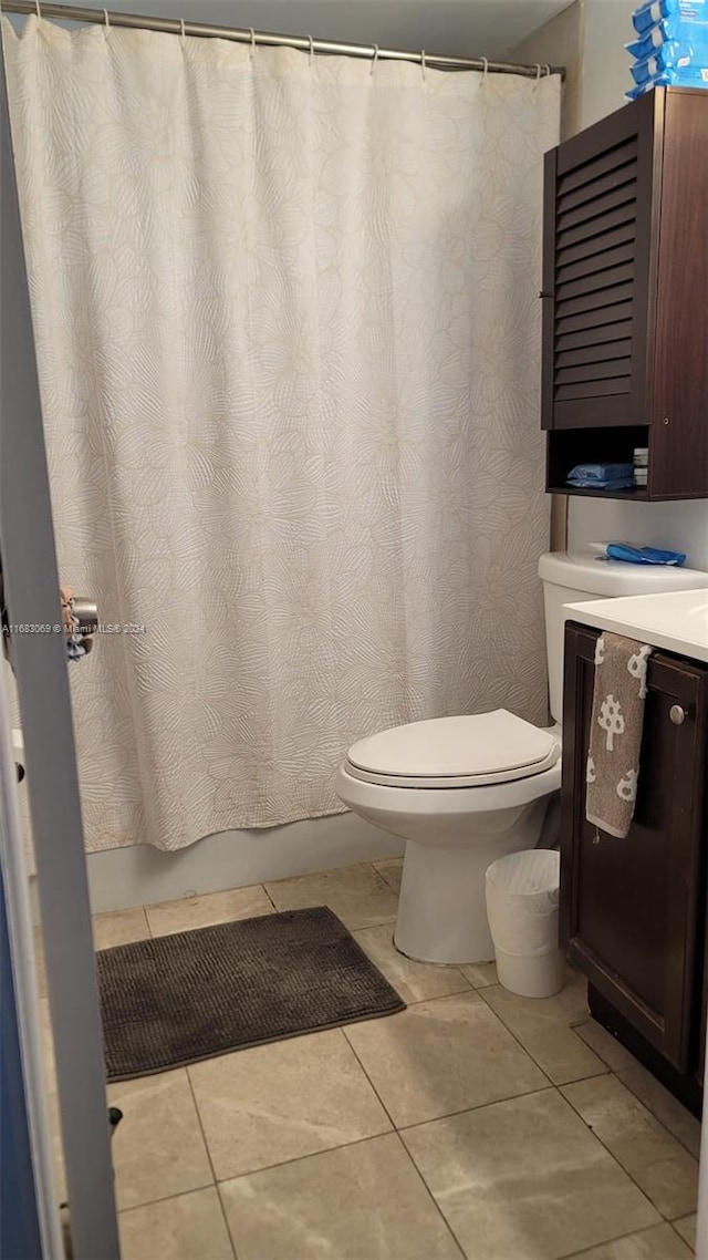 bathroom with vanity, toilet, tile patterned floors, and curtained shower