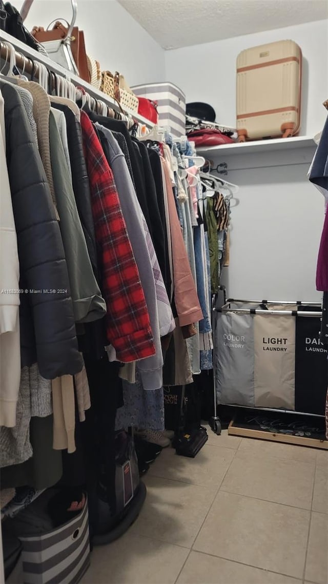 walk in closet with tile patterned floors