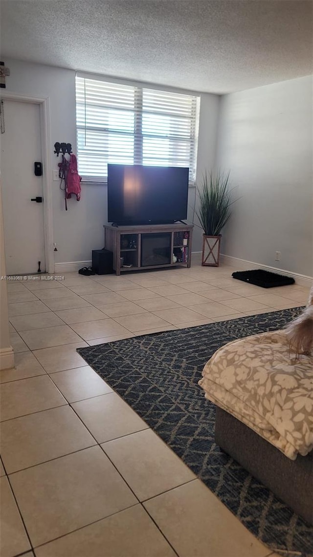 living room featuring a textured ceiling and tile patterned floors