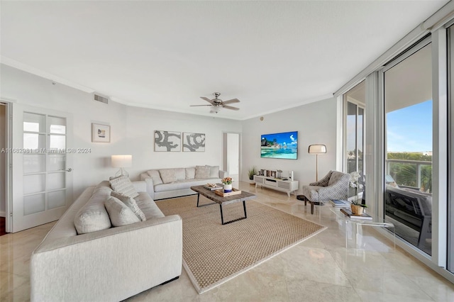 living room featuring ornamental molding and ceiling fan