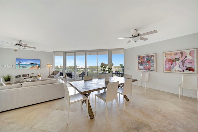 dining room with floor to ceiling windows and ceiling fan