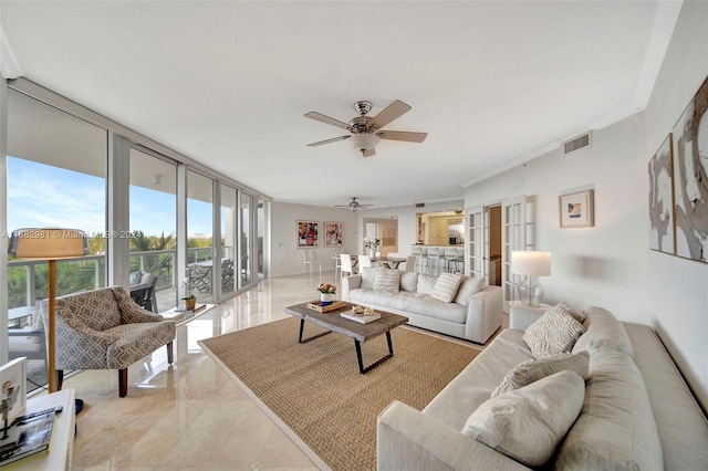 living room featuring expansive windows, ornamental molding, and ceiling fan