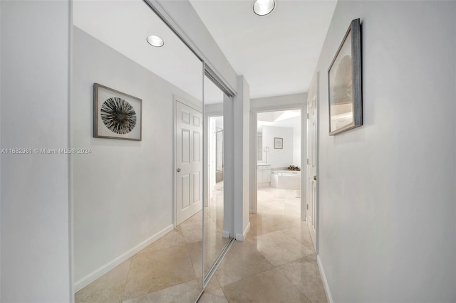 hall with light tile patterned floors