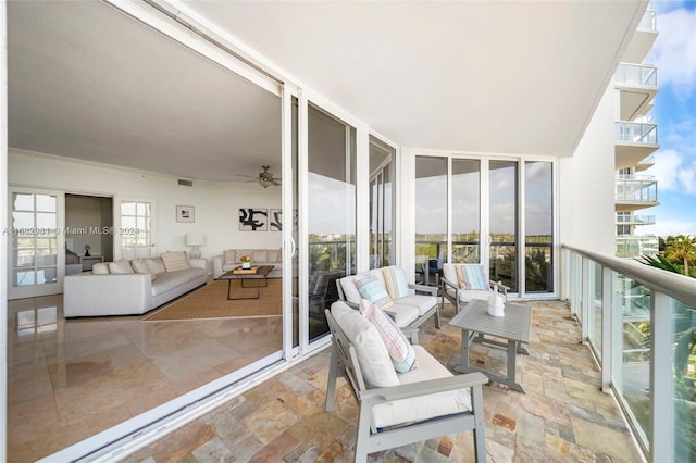 balcony with outdoor lounge area and ceiling fan