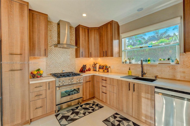 kitchen with backsplash, appliances with stainless steel finishes, light tile patterned floors, sink, and wall chimney exhaust hood