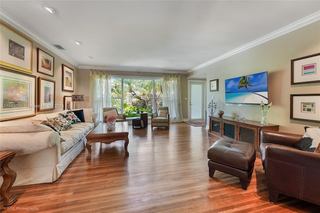 living room with ornamental molding and hardwood / wood-style flooring