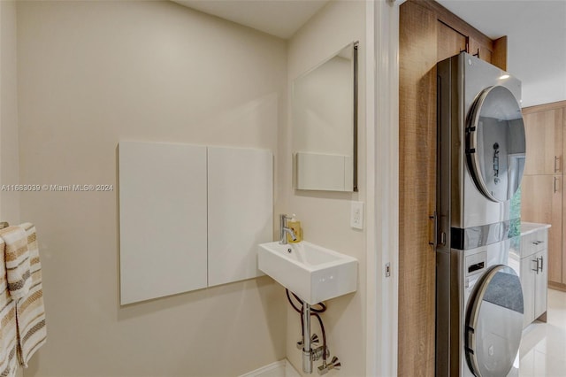 laundry area featuring sink and stacked washer and dryer