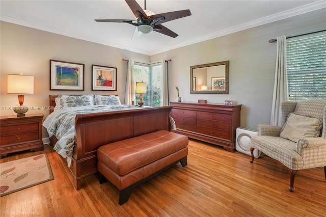 bedroom with light hardwood / wood-style floors, ceiling fan, and ornamental molding