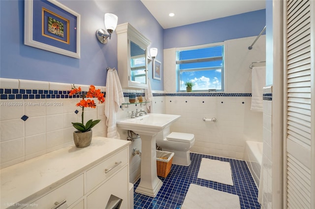 bathroom featuring tile walls, tile patterned flooring, tiled shower / bath combo, and toilet