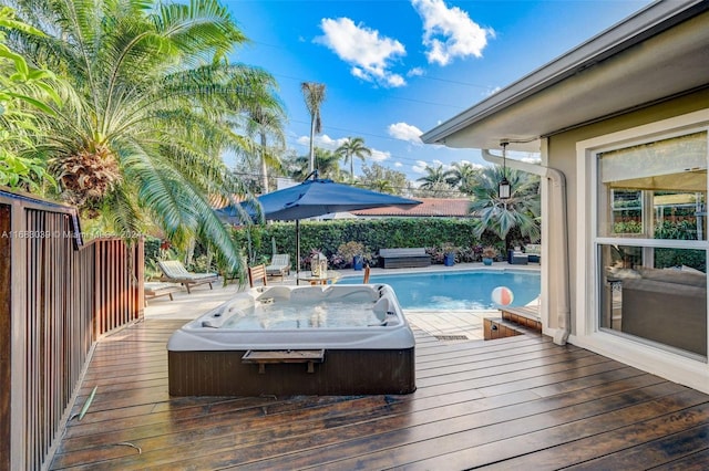 deck with an outdoor hot tub