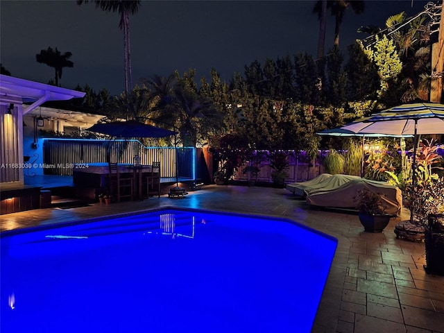 pool at night with a patio