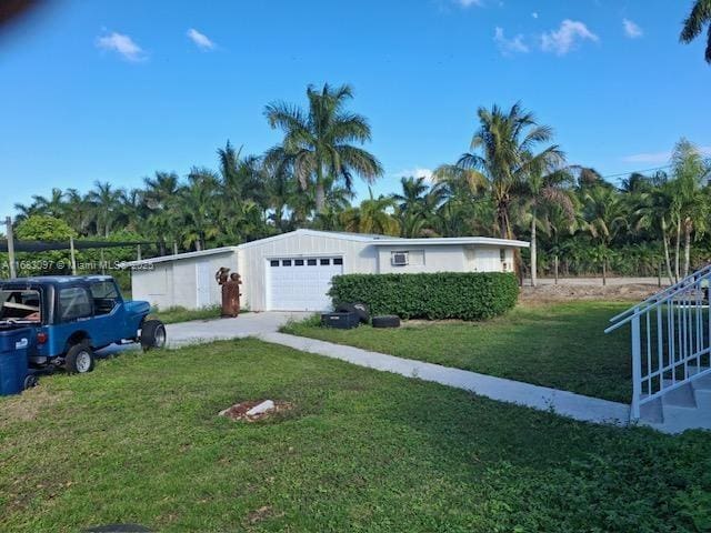 exterior space with a garage and a front lawn