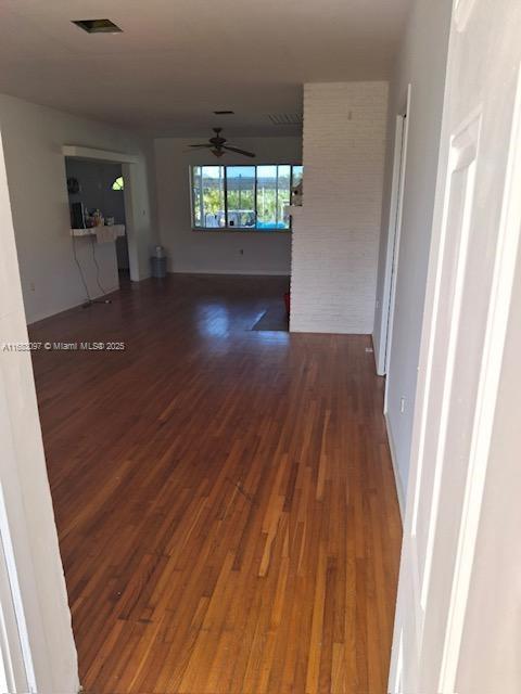 interior space with ceiling fan and dark hardwood / wood-style floors