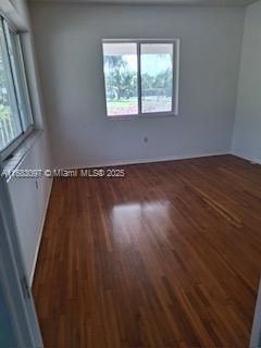 empty room featuring dark hardwood / wood-style floors