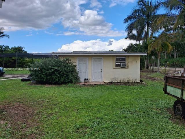 view of outbuilding with a yard