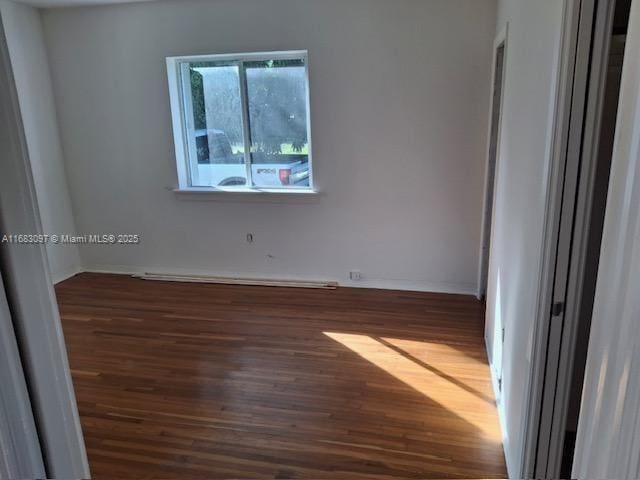 spare room featuring dark hardwood / wood-style floors