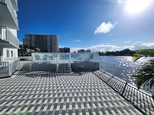 view of patio / terrace with a water view and a balcony