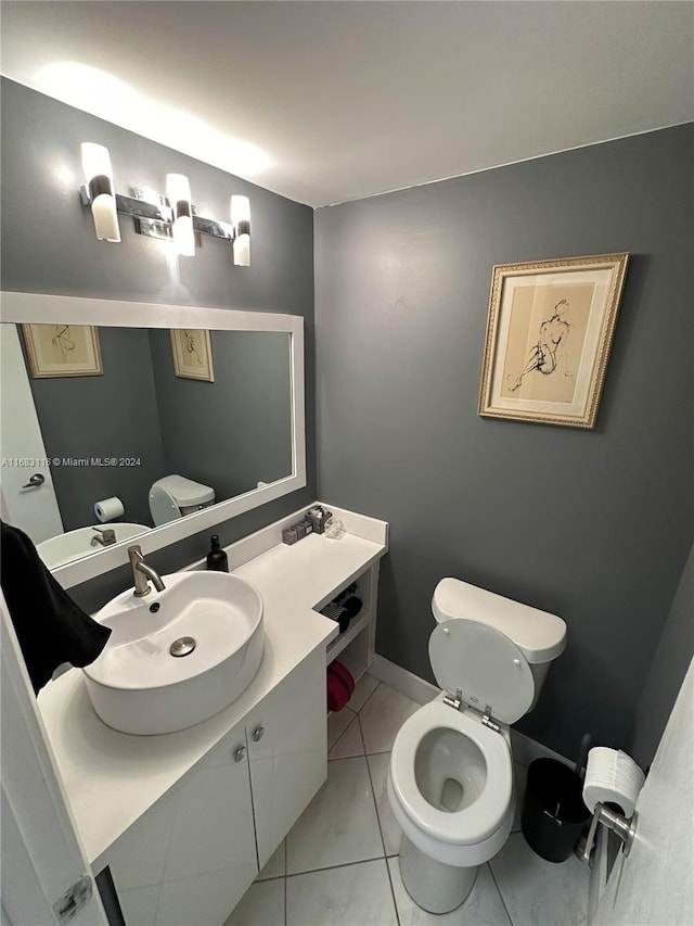 bathroom with vanity, toilet, and tile patterned floors