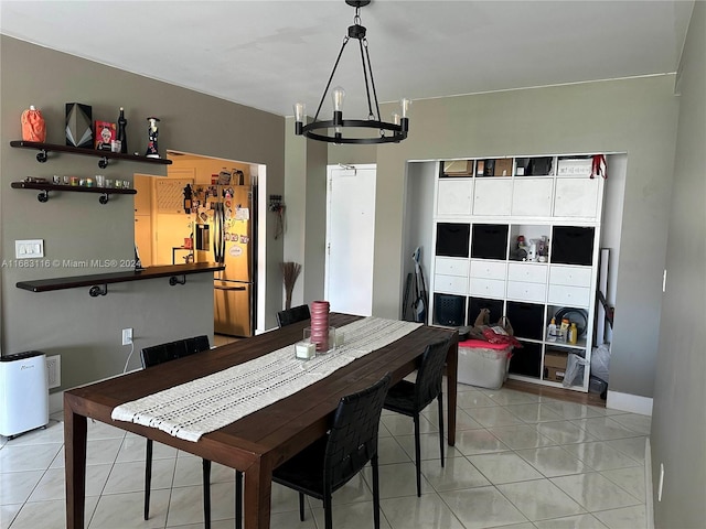 dining area with an inviting chandelier and light tile patterned floors