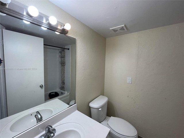 full bathroom featuring toilet, tiled shower / bath combo, and vanity