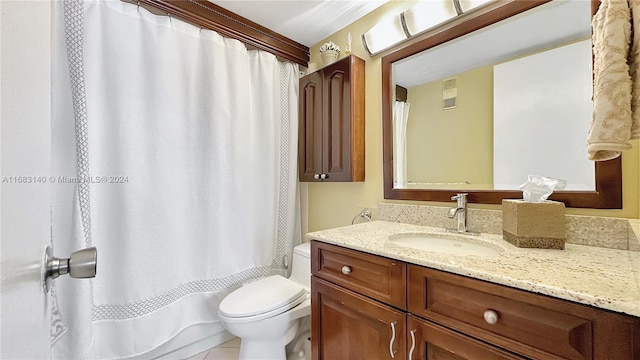 bathroom featuring tile patterned flooring, vanity, and toilet