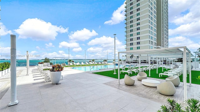 view of patio / terrace with a community pool and a water view