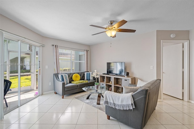 tiled living room featuring a textured ceiling and ceiling fan