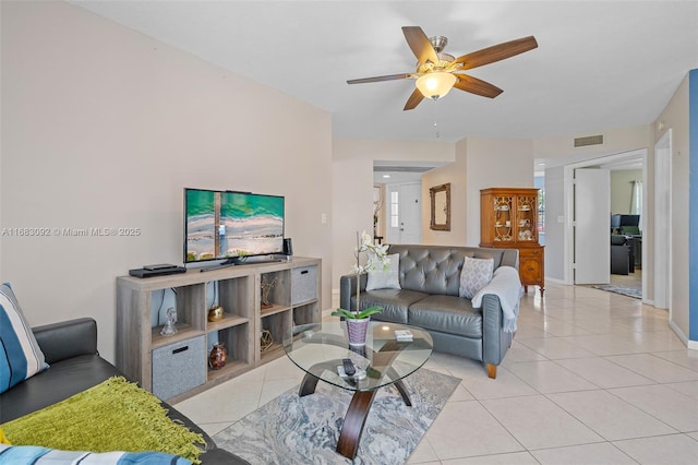 living room with light tile patterned floors and ceiling fan