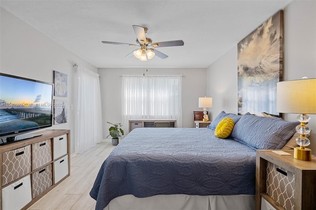 bedroom with ceiling fan and light hardwood / wood-style flooring