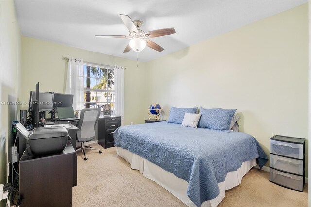 bedroom featuring light carpet and ceiling fan