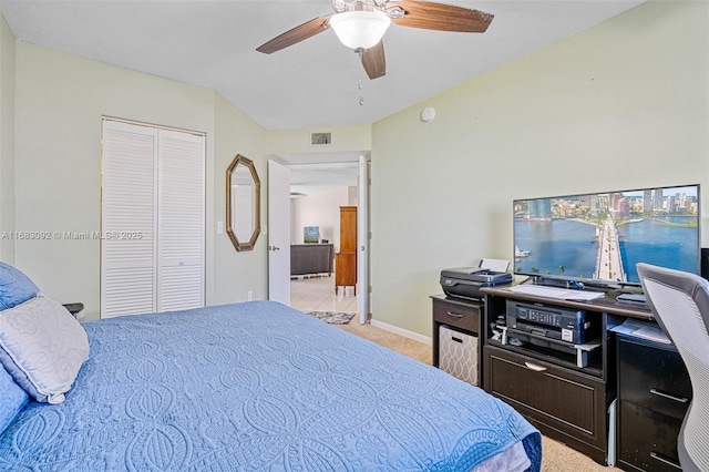 bedroom with ceiling fan, a closet, and light carpet