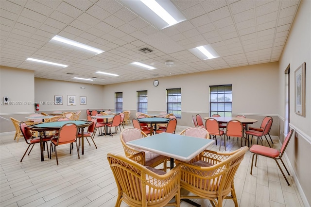 dining area featuring a paneled ceiling