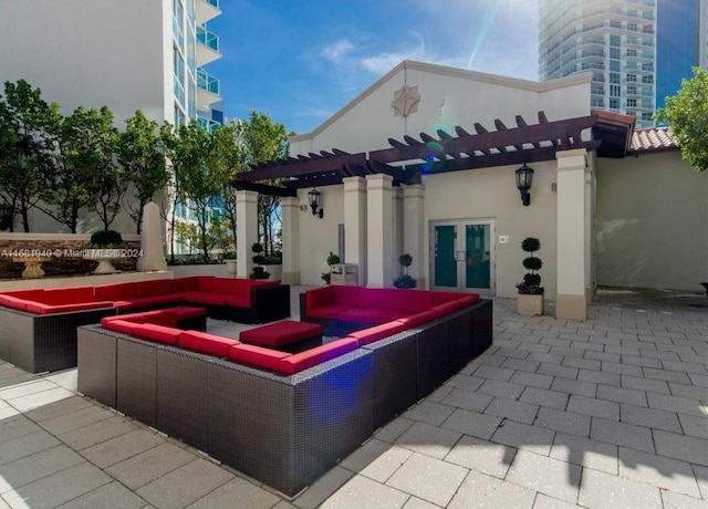 view of patio / terrace featuring a hot tub, french doors, and a pergola