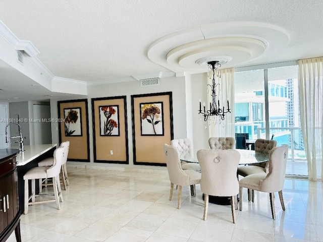 dining room with crown molding, a textured ceiling, a notable chandelier, and light tile patterned floors