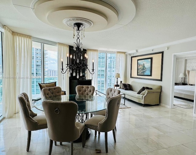 tiled dining space featuring ornamental molding, a notable chandelier, a textured ceiling, and plenty of natural light