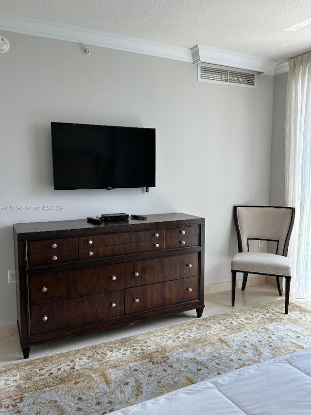 tiled bedroom featuring ornamental molding and a textured ceiling