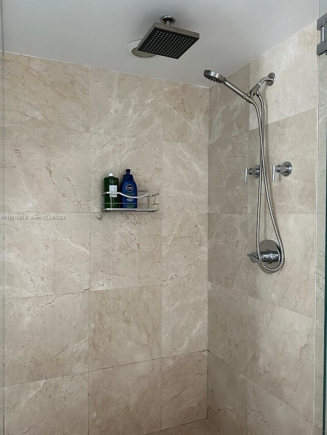 bathroom with tiled shower