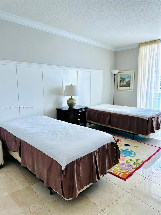 bedroom featuring crown molding and a textured ceiling