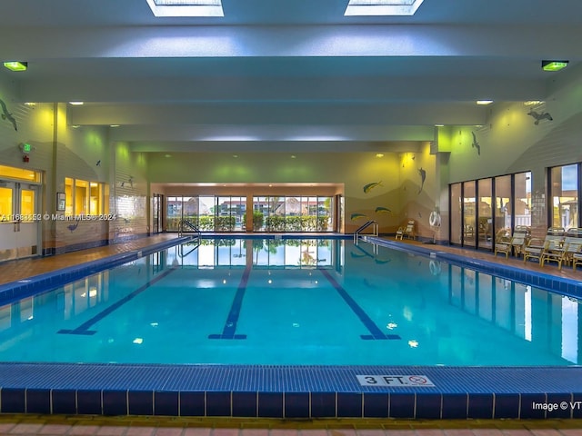 view of swimming pool featuring a skylight