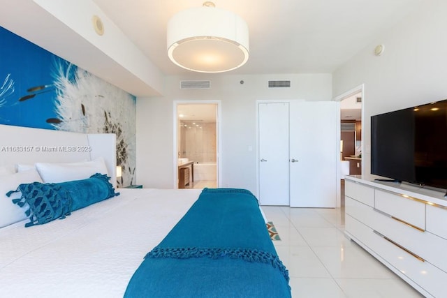485 Brickell Ave Unit 3906, Miami, FL 33131 - bedroom featuring light tile patterned floors and ensuite bath