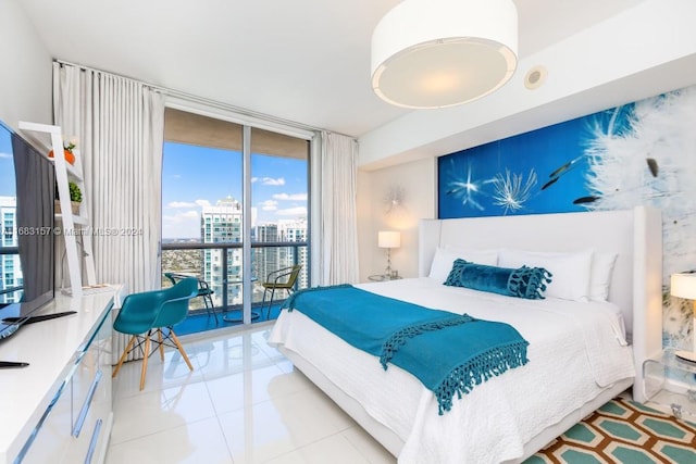 bedroom featuring access to outside, light tile patterned floors, and expansive windows