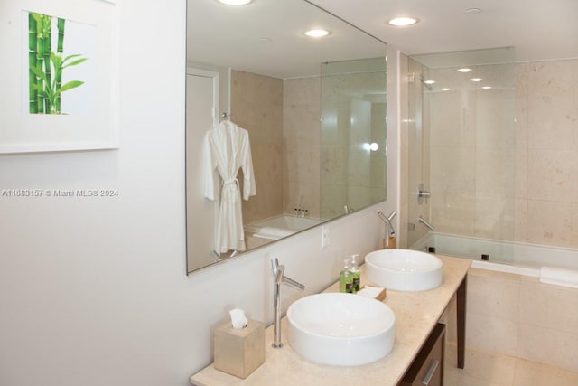 bathroom with vanity, tile patterned flooring, and tiled shower / bath