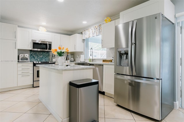 kitchen featuring a center island, white cabinets, and stainless steel appliances