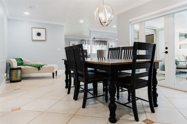 dining space with ornamental molding, light tile patterned flooring, and ceiling fan with notable chandelier