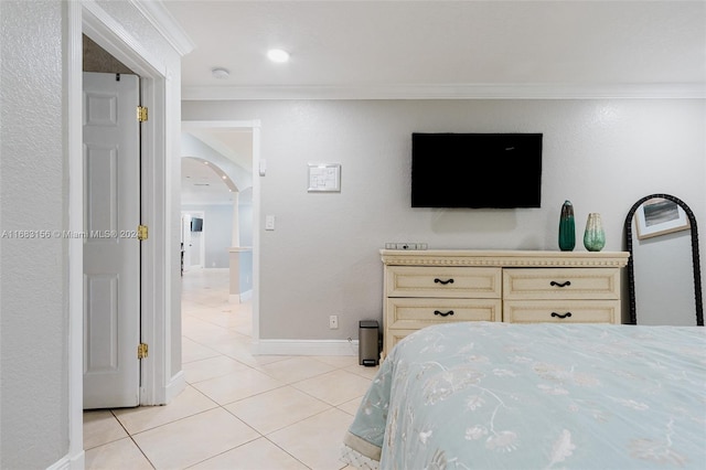 bedroom with crown molding and light tile patterned floors